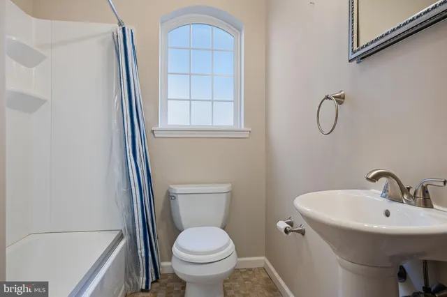 a view of a livingroom with furniture and a window