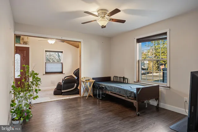a room with gym equipment and wooden floor