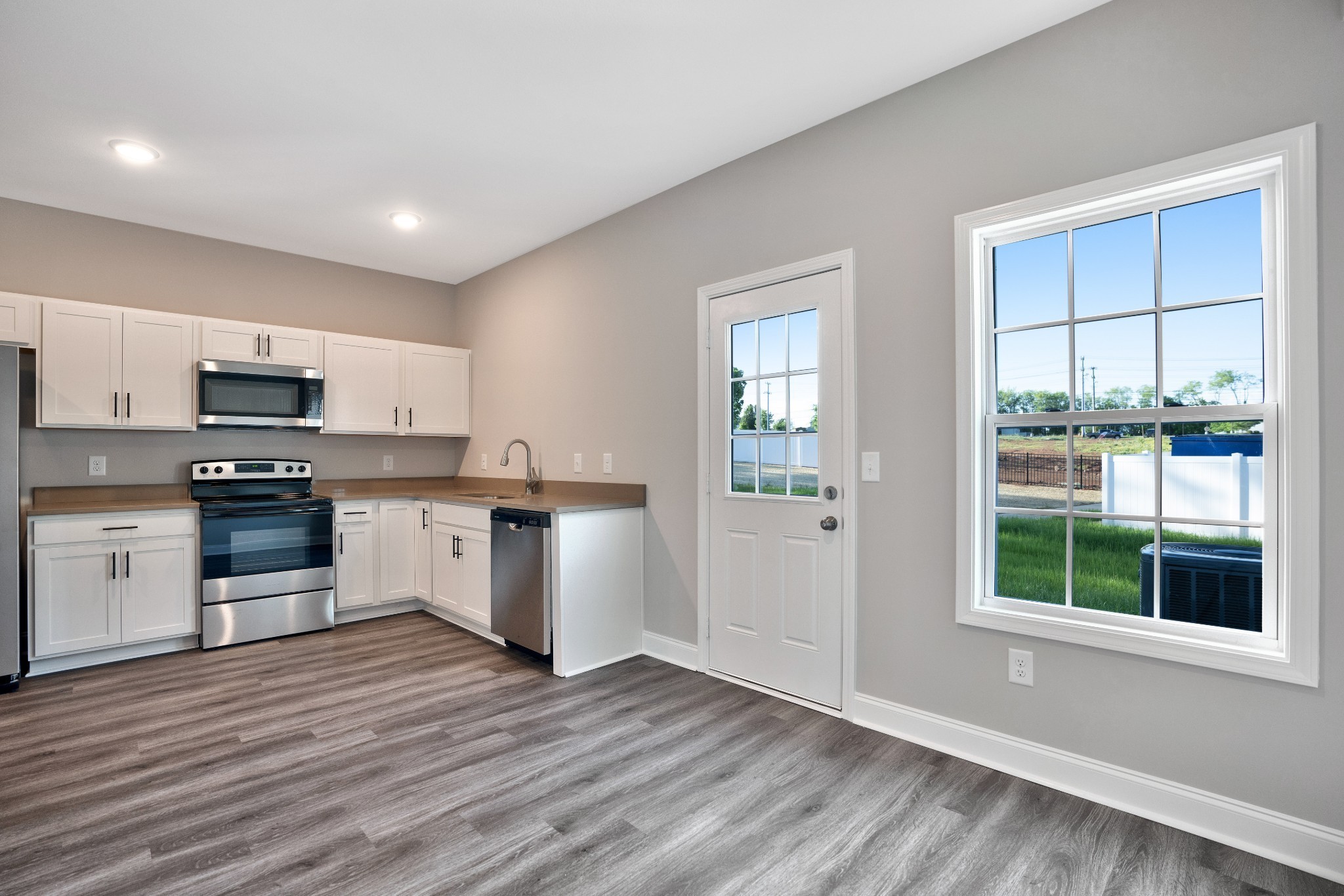 2500 Tiny Town Road, Unit 70 Clarksville, TN 37042 - Photo 13 of 27 a kitchen with wooden floors and white appliances