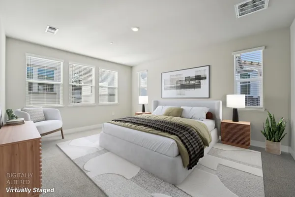 a spacious bedroom with a large bed and a couch