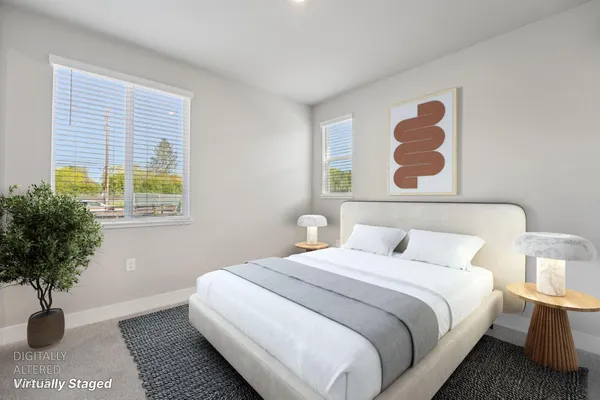 a bedroom with a bed and a potted plant