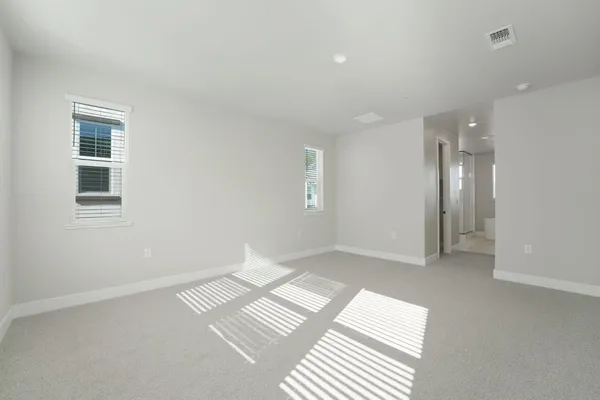 a view of an empty room and a bathroom