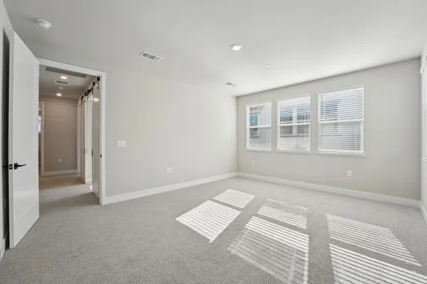 an empty room with windows and closet