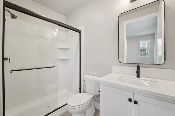 a bathroom with a toilet sink and a mirror