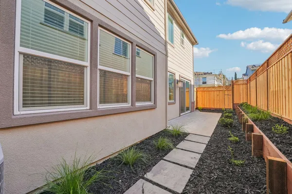 a house with a white door next to a yard