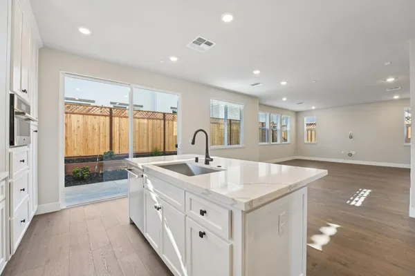 a large white kitchen with a large window