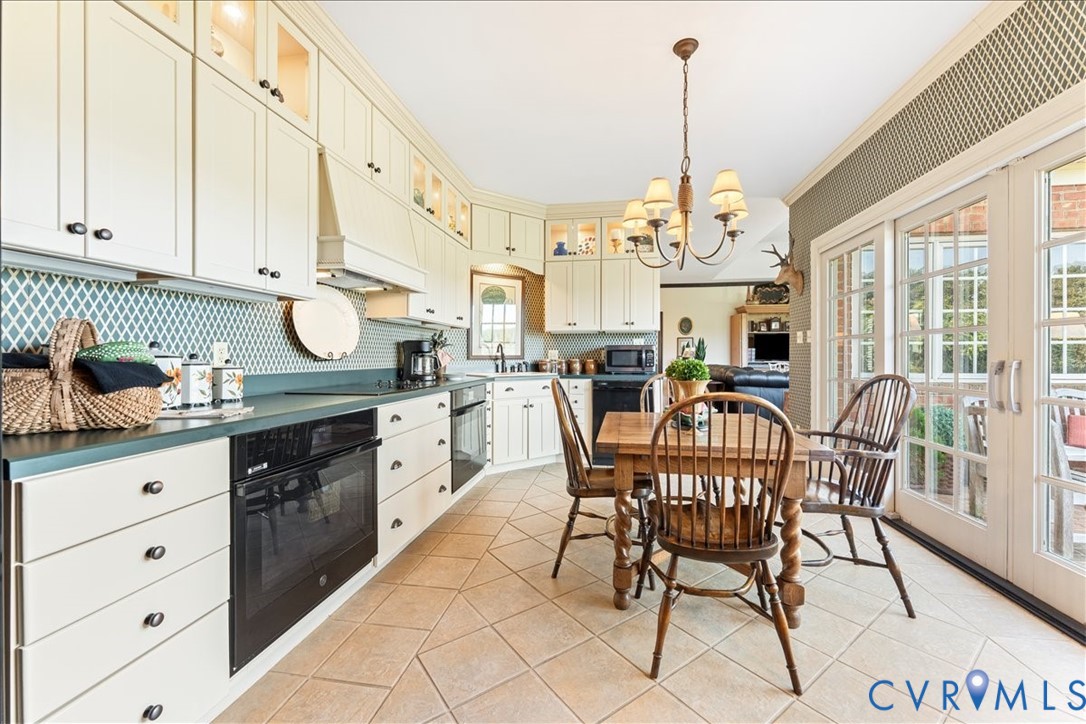3581 Richards Run Powhatan, VA 23139 - Photo 19 of 50 a kitchen with stainless steel appliances granite countertop a stove a sink dishwasher with a dining table and chairs