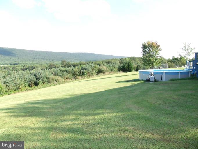 4307 Highland Ridge Road Berkeley Springs, WV 25411 - Photo 8 of 21 a view of an outdoor space and a yard