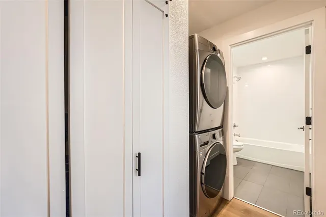a view of a kitchen with wooden floor and electronic appliances