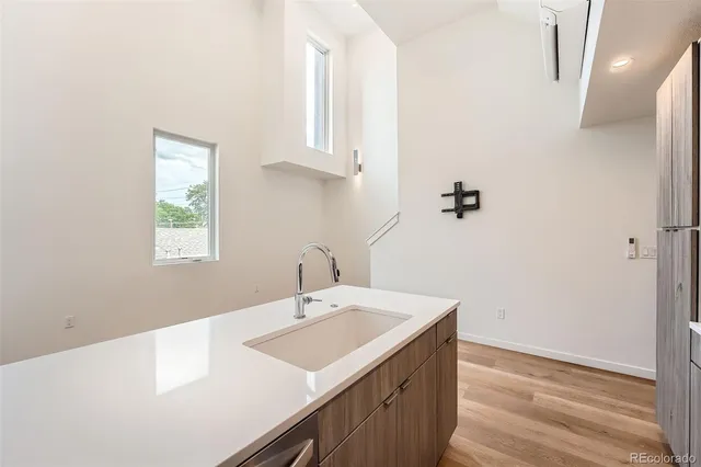 a view of kitchen with sink wooden floor and electronic appliances
