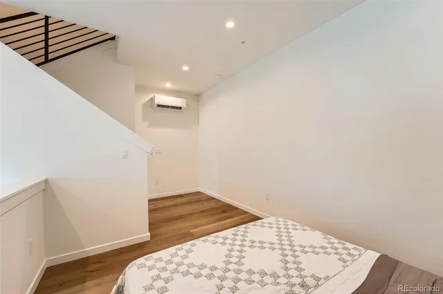 a bed sitting in a bedroom next to a window