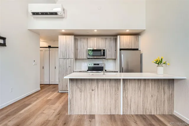 a kitchen with stainless steel appliances a sink stove refrigerator and cabinets