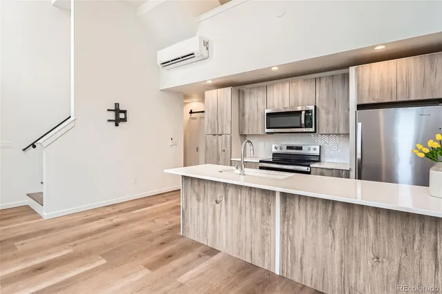 a kitchen with stainless steel appliances a stove microwave and a refrigerator