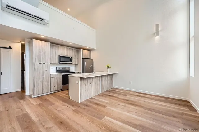 a kitchen with stainless steel appliances a refrigerator and a stove top oven