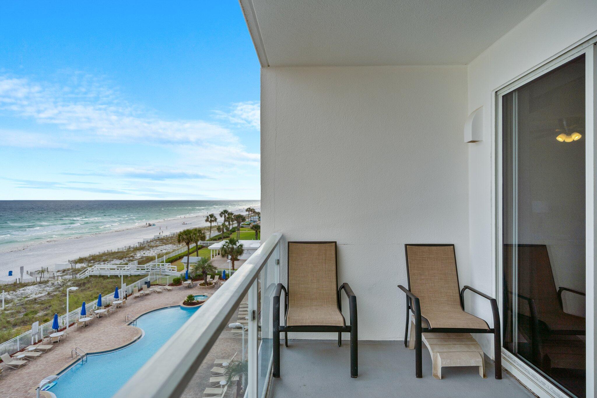 1080 Highway 98, Unit 403 Destin, FL 32541 - Photo 12 of 65 a view of a chairs and table in a balcony