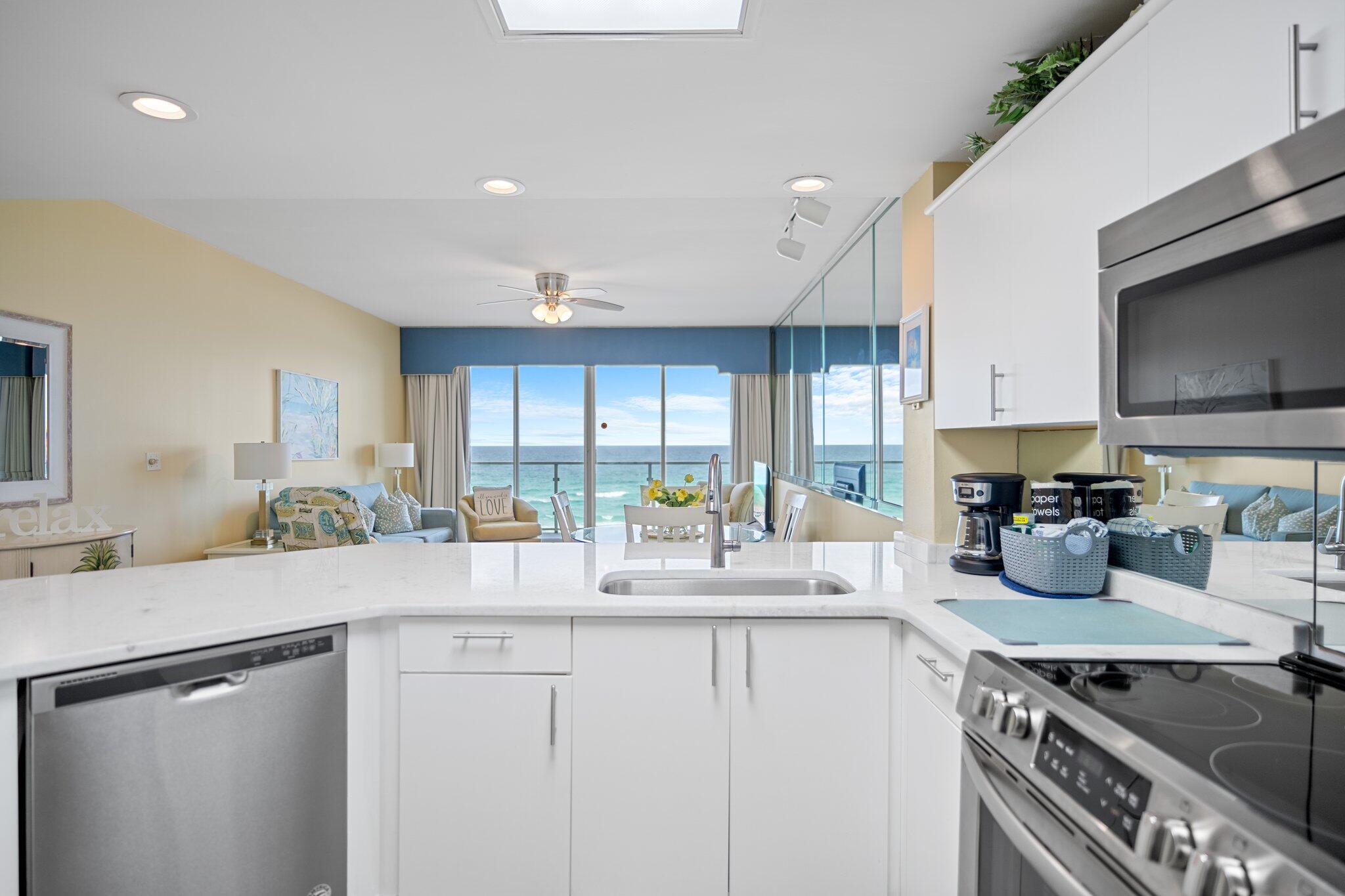1080 Highway 98, Unit 403 Destin, FL 32541 - Photo 15 of 65 a kitchen with sink stove and cabinets