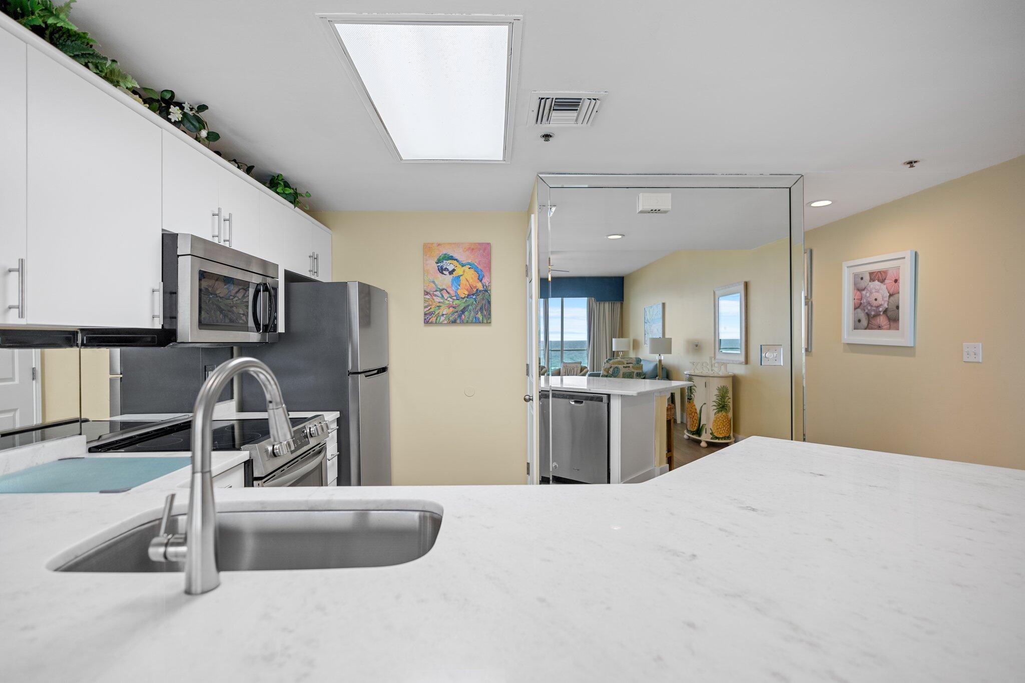 1080 Highway 98, Unit 403 Destin, FL 32541 - Photo 18 of 65 a kitchen with kitchen island granite countertop a sink stainless steel appliances and cabinets