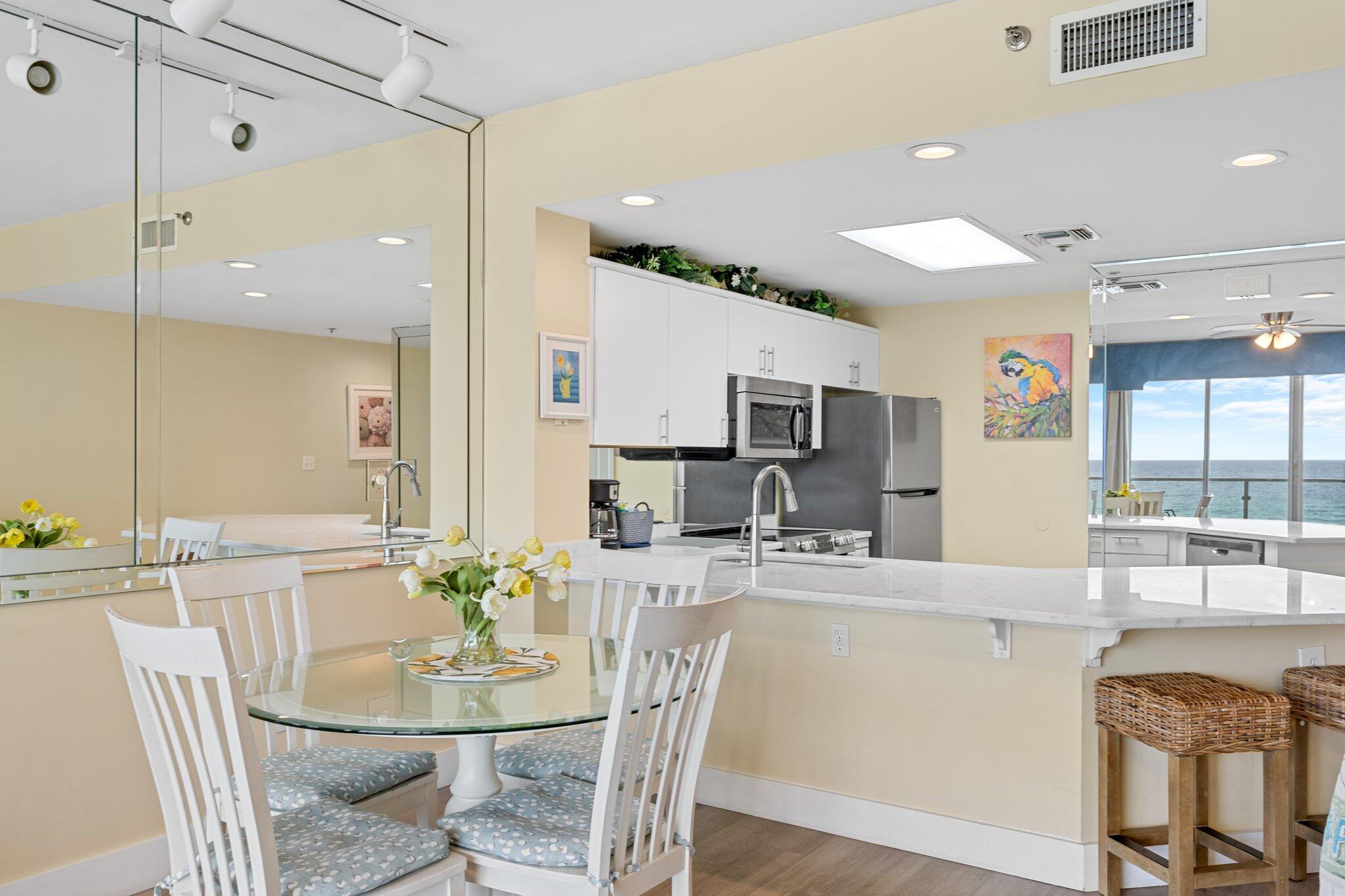 1080 Highway 98, Unit 403 Destin, FL 32541 - Photo 21 of 65 a dining room with stainless steel appliances kitchen island granite countertop a dining table chairs and couches