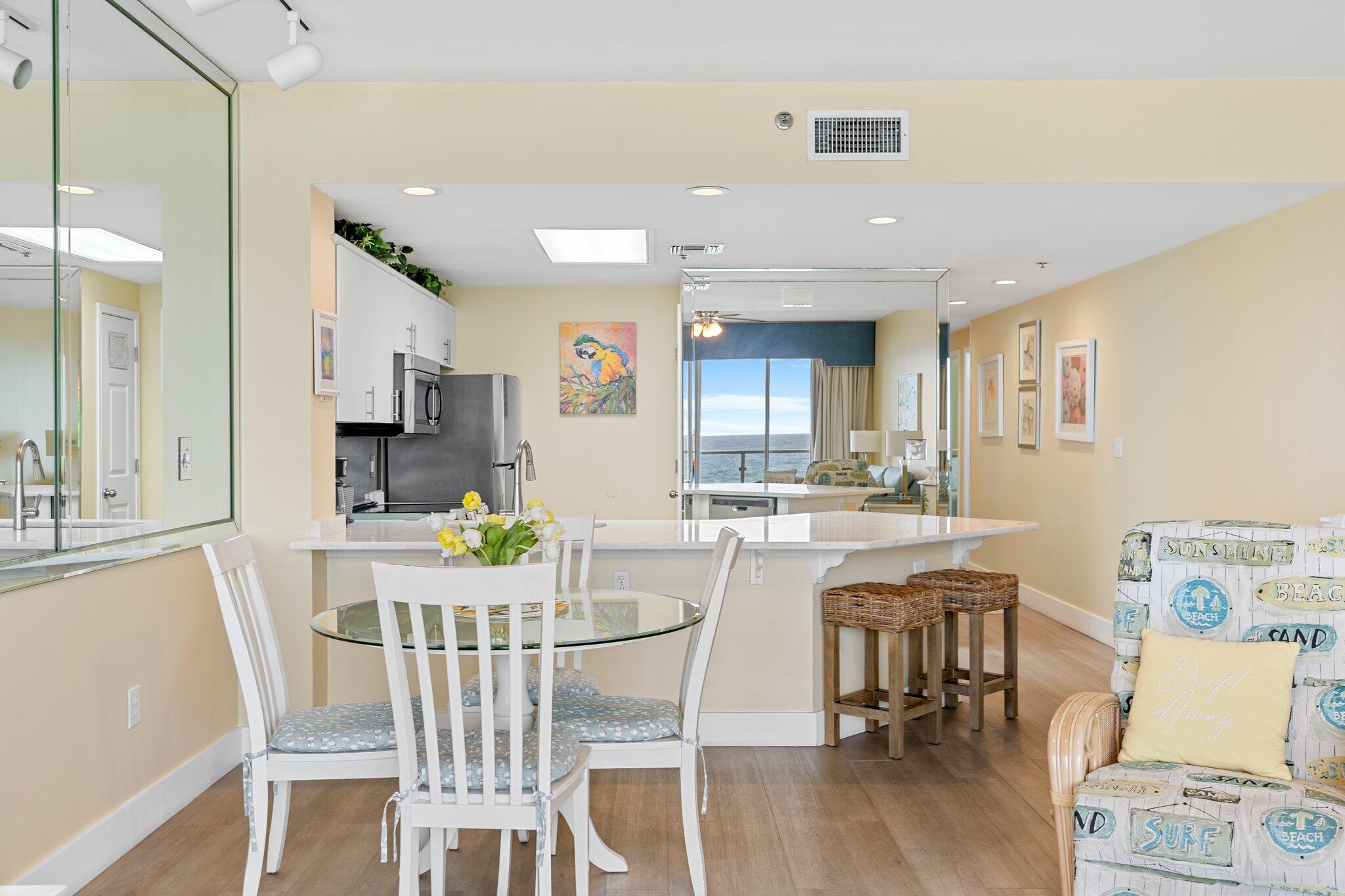 1080 Highway 98, Unit 403 Destin, FL 32541 - Photo 22 of 65 a view of a dining room with furniture and wooden floor