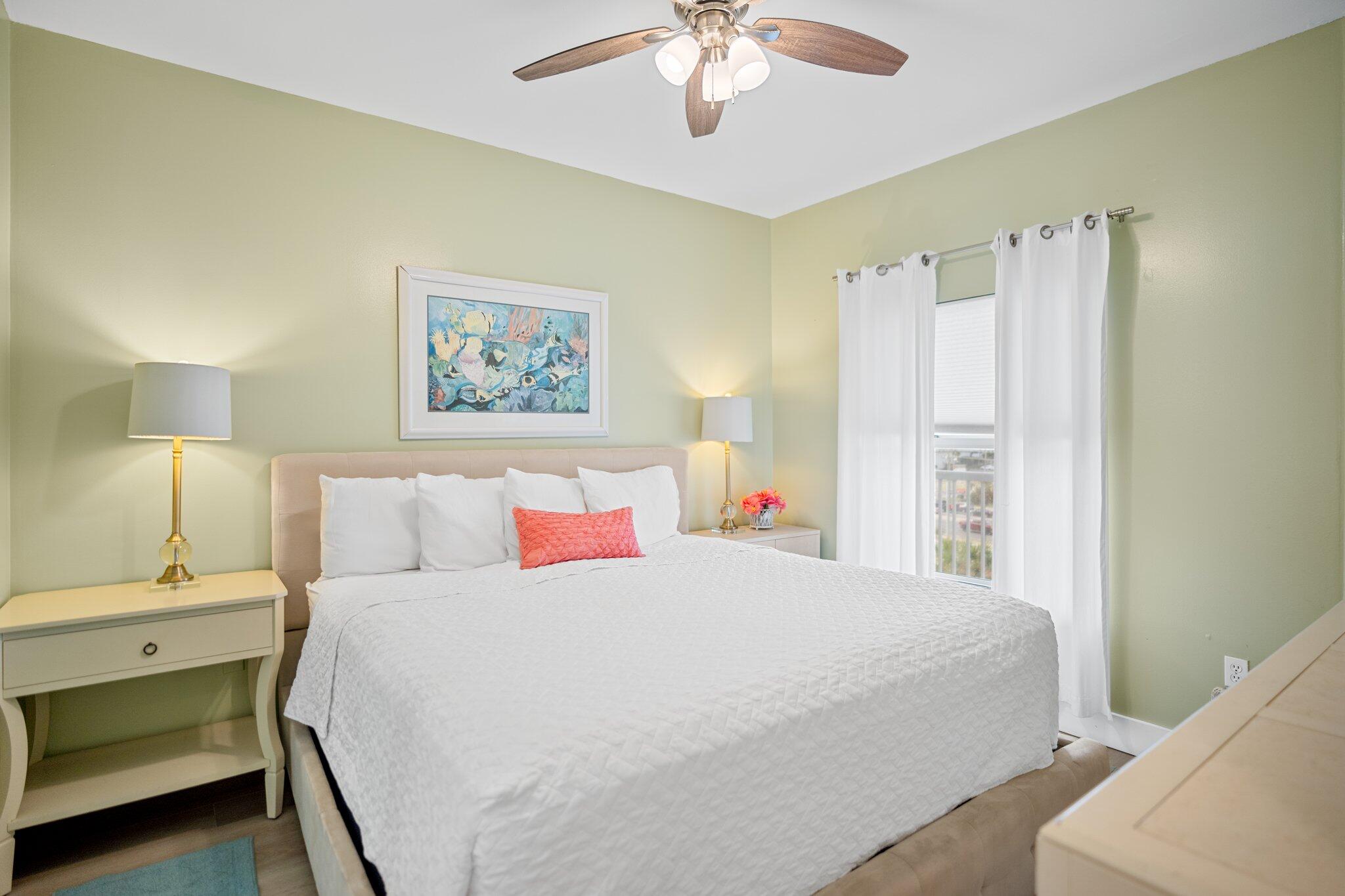 1080 Highway 98, Unit 403 Destin, FL 32541 - Photo 23 of 65 a bedroom with a large bed and a chandelier