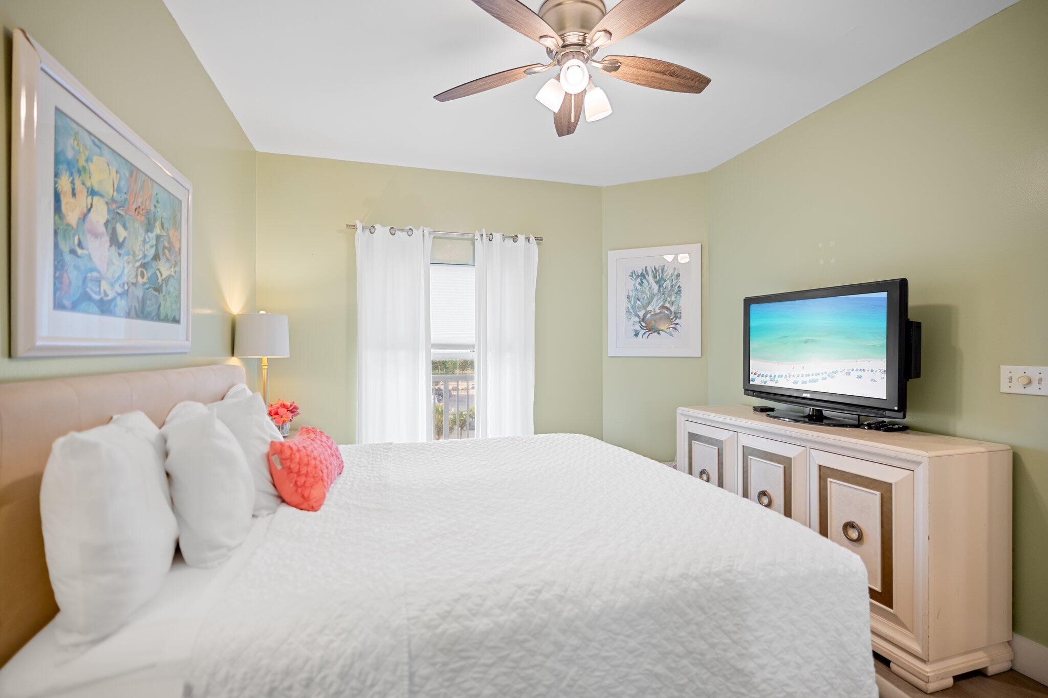 1080 Highway 98, Unit 403 Destin, FL 32541 - Photo 24 of 65 a bedroom with a bed and a flat screen tv