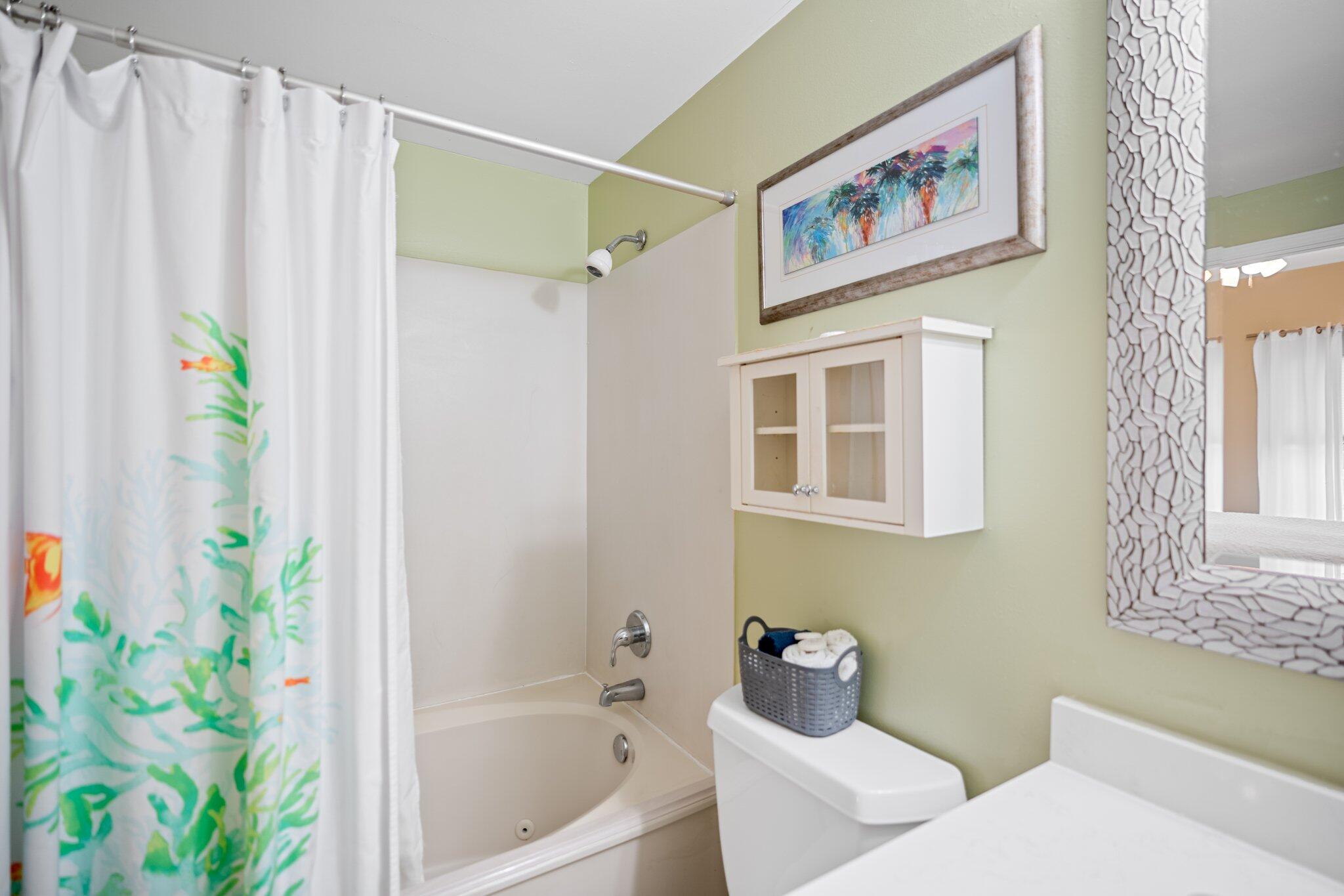 1080 Highway 98, Unit 403 Destin, FL 32541 - Photo 26 of 65 a bathroom with a bathtub and a shower