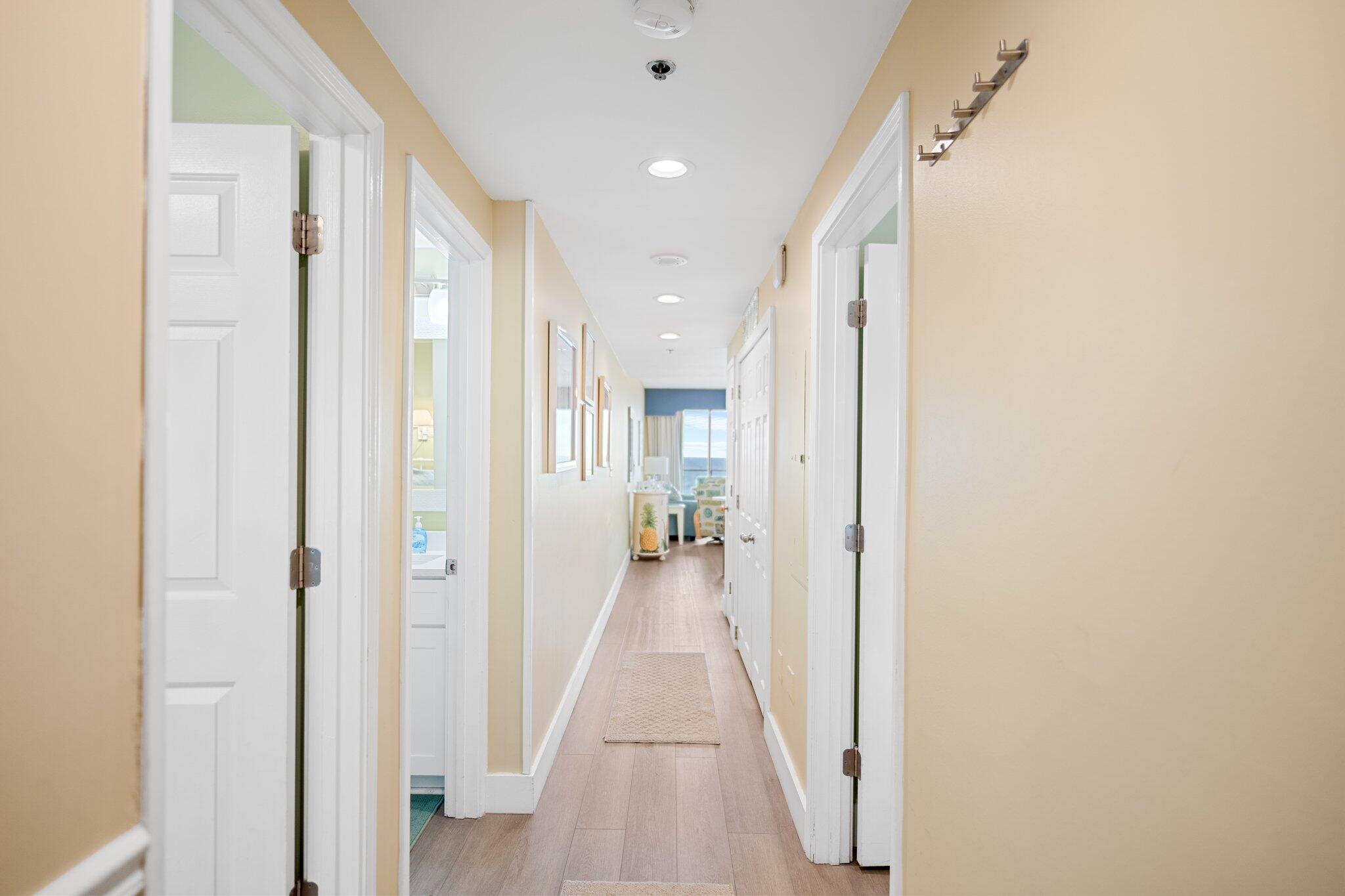 1080 Highway 98, Unit 403 Destin, FL 32541 - Photo 31 of 65 a view of a hallway with wooden floor and a bathroom