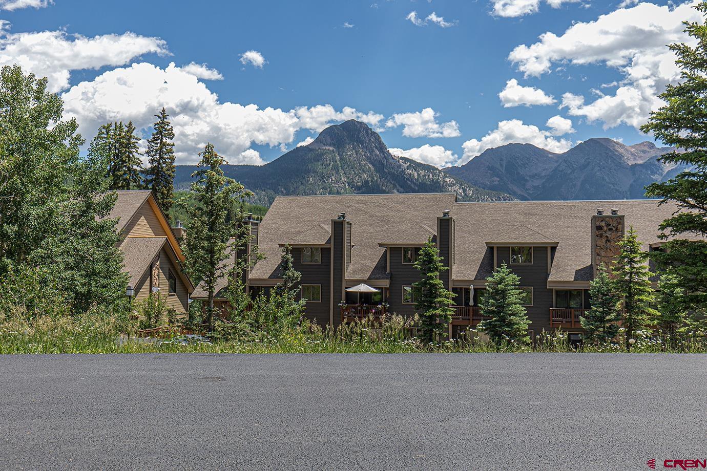 a view of a house with a flower garden