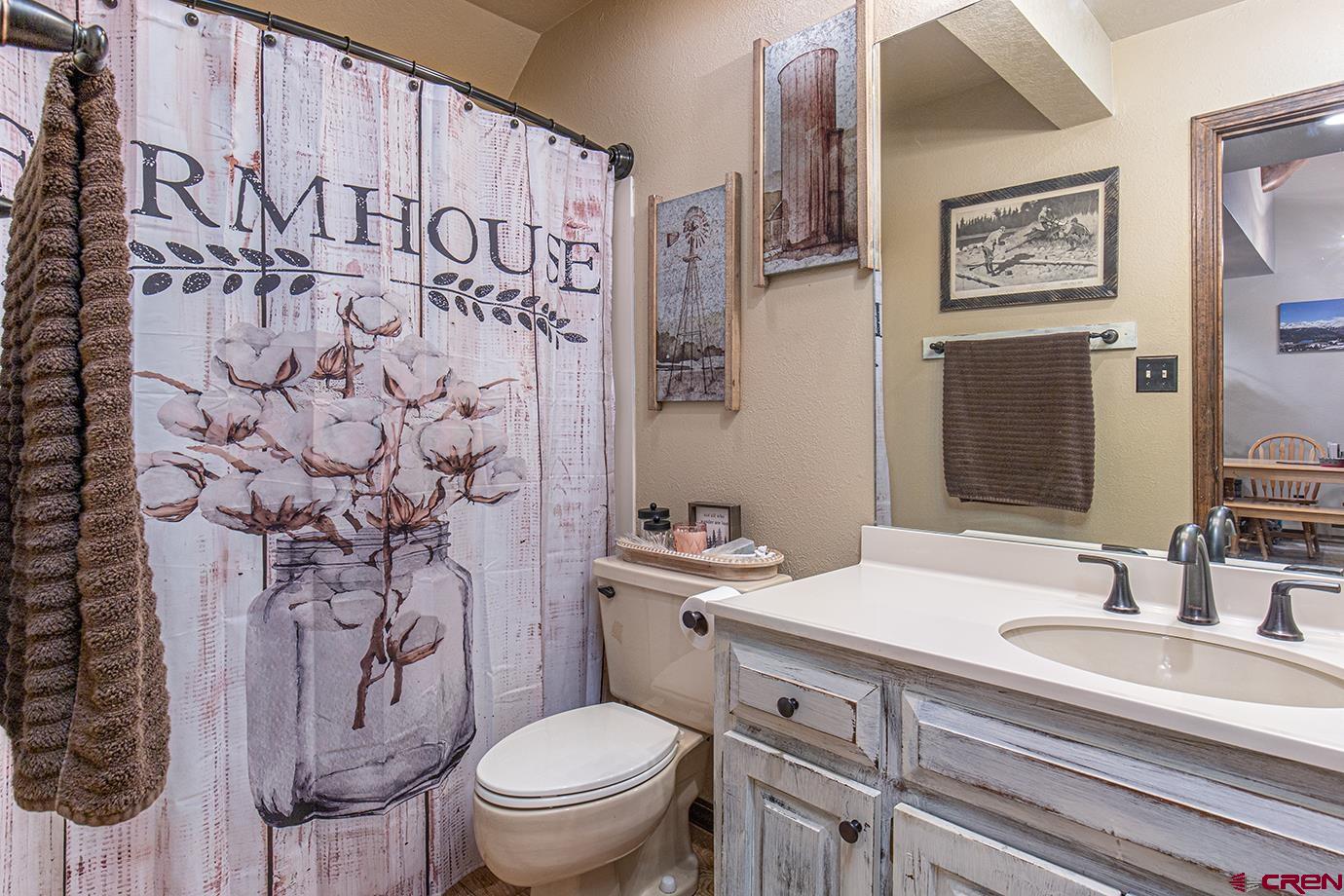 50827 Highway 550, Unit 330 Durango, CO 81301 - Photo 16 of 31 a bathroom with a granite countertop toilet sink and mirror