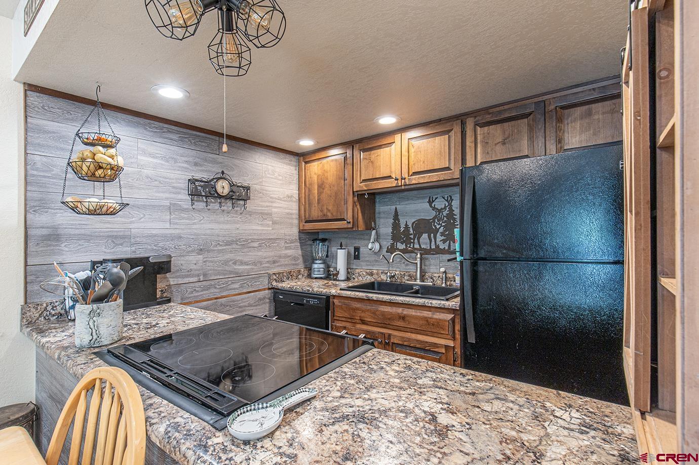 50827 Highway 550, Unit 330 Durango, CO 81301 - Photo 3 of 31 a kitchen with stainless steel appliances granite countertop a sink and a refrigerator
