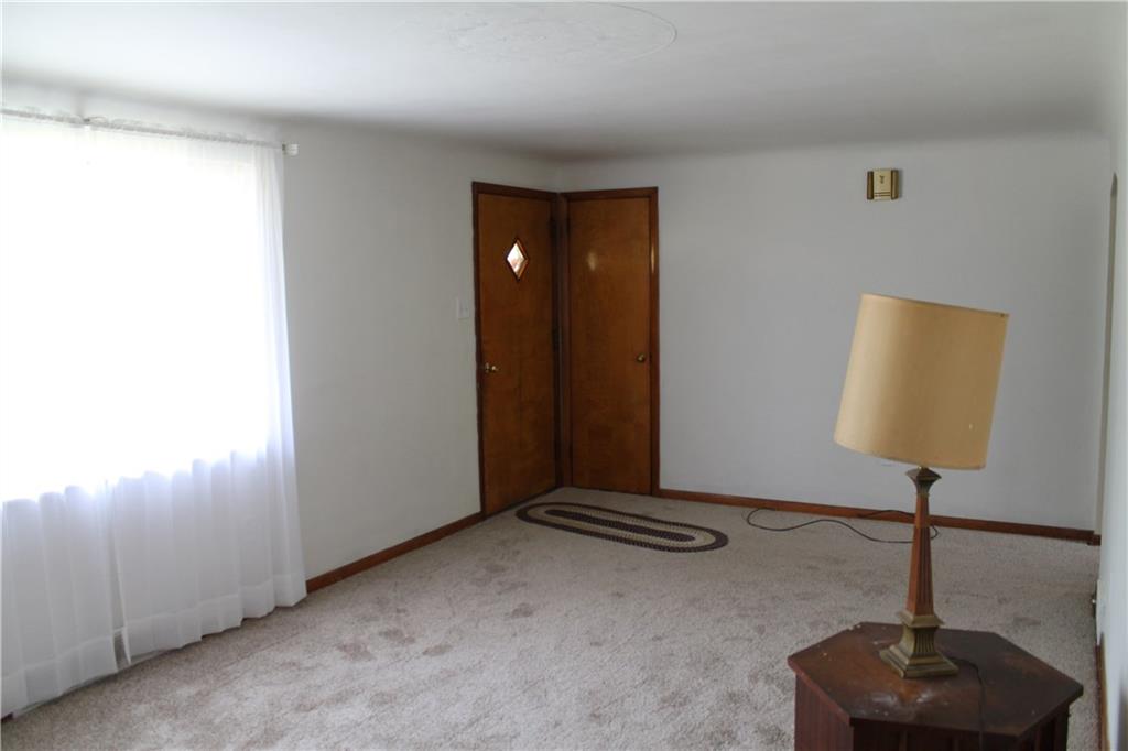 104 KIngs Road Braddock Hills, PA 15221 - Photo 6 of 23 Living room features a coat closet and good natural light.