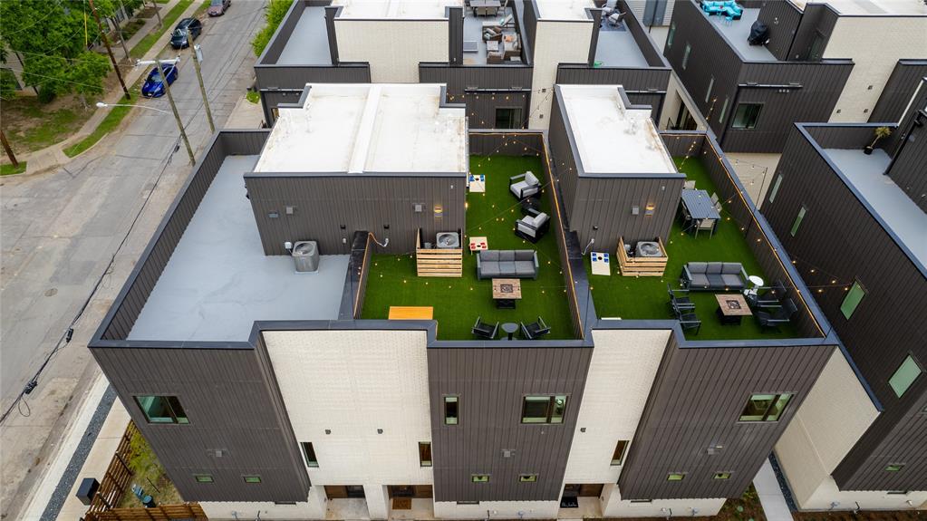 an aerial view of house with outdoor space and parking