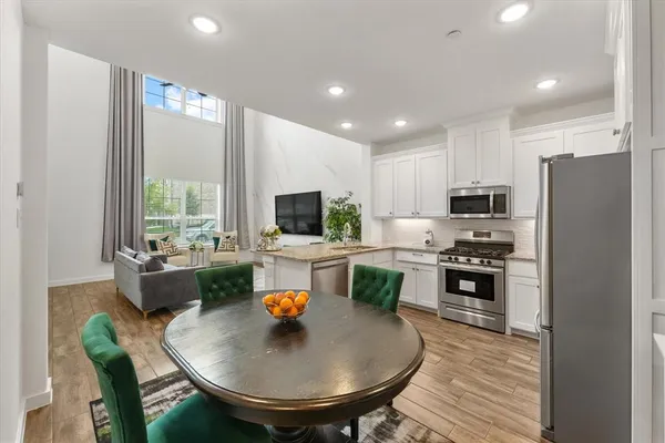 a kitchen with a sink a kitchen island and stainless steel appliances