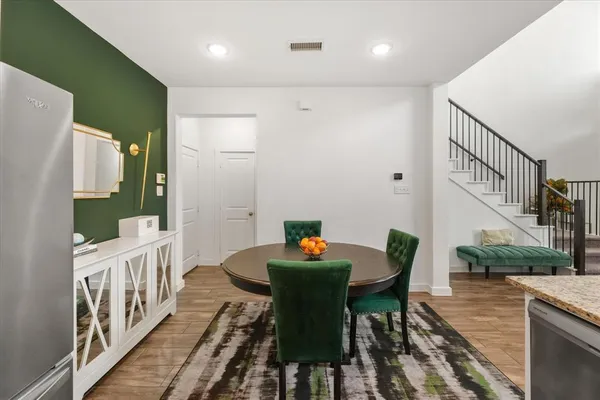 a dining room with furniture a rug and wooden floor