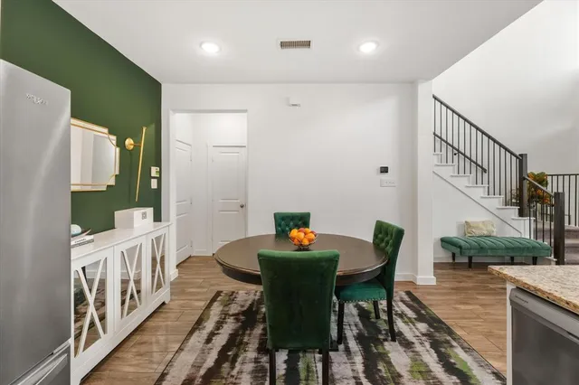 a dining room with furniture a rug and wooden floor