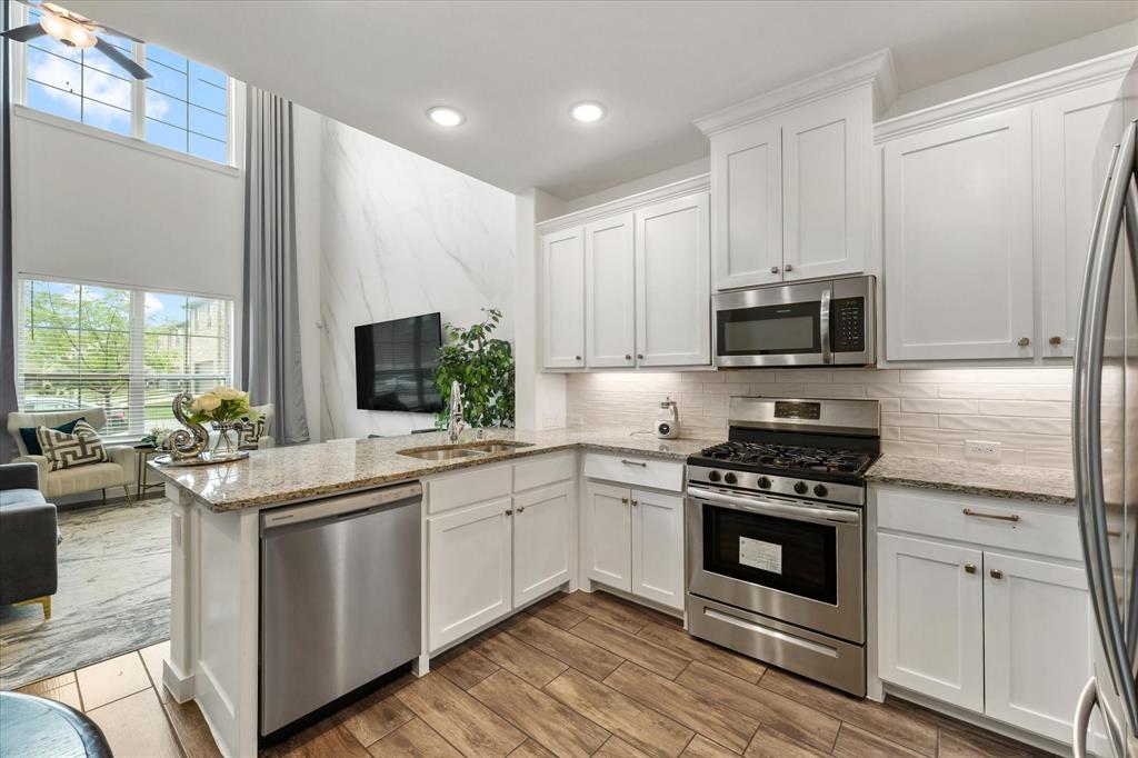 5824 Ridgeline Drive McKinney, TX 75070 - Photo 17 of 31 a kitchen with a sink stove and cabinets