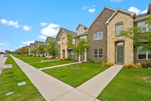 a view of a big building with a big yard and plants