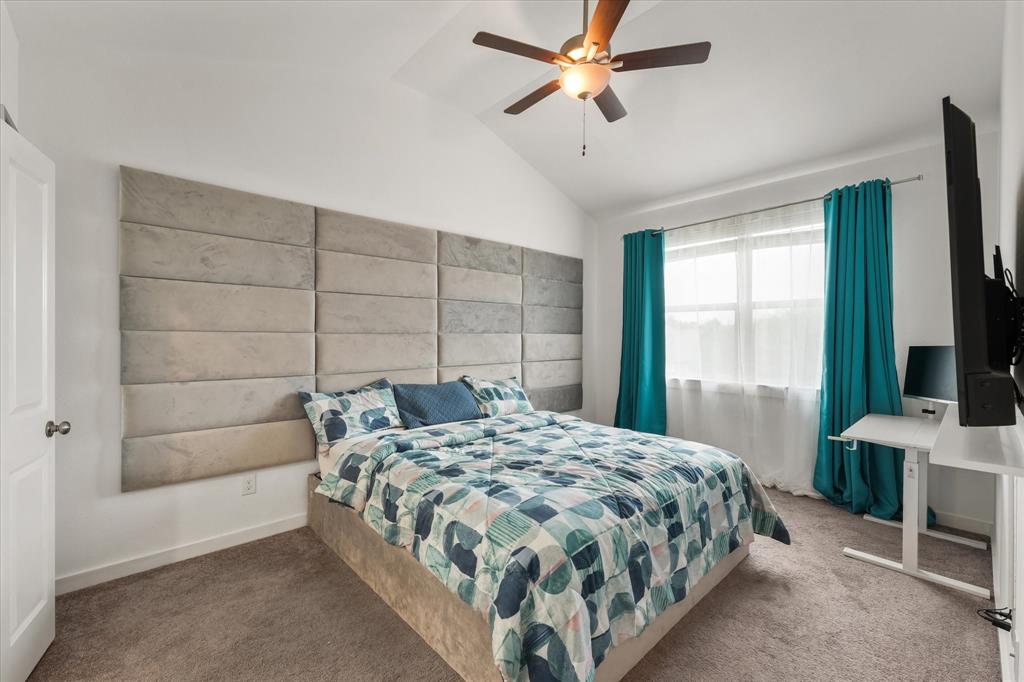 5824 Ridgeline Drive McKinney, TX 75070 - Photo 21 of 31 a bedroom with a bed and a flat tv screen on the dresser