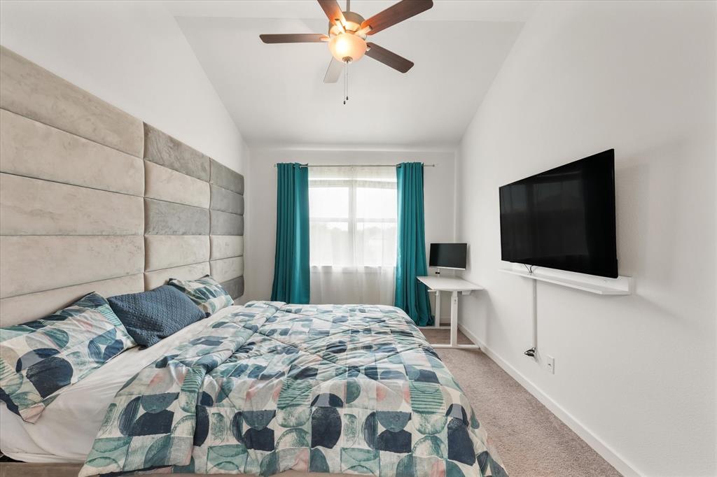 5824 Ridgeline Drive McKinney, TX 75070 - Photo 22 of 31 a bedroom with a bed and a flat screen tv