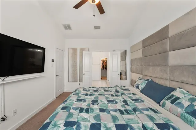 a bedroom with a bed and a television