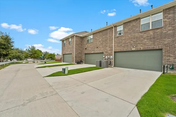 a view of a house with a yard and garage