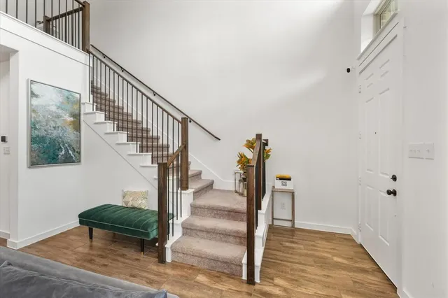 a view of entryway and hall with wooden floor