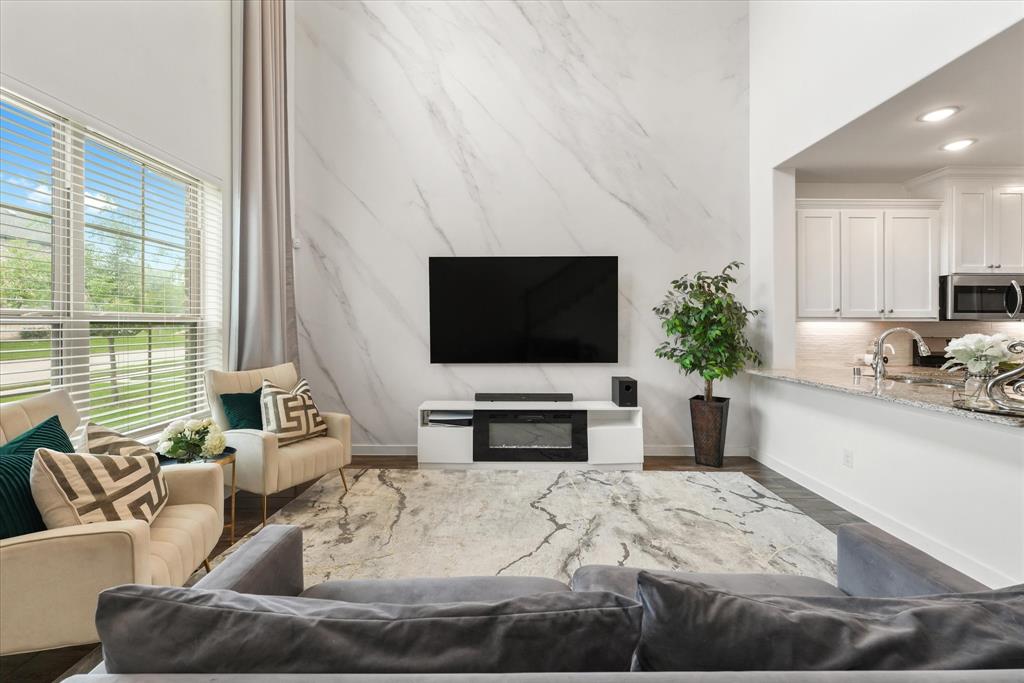 5824 Ridgeline Drive McKinney, TX 75070 - Photo 6 of 31 a living room with furniture and a flat screen tv