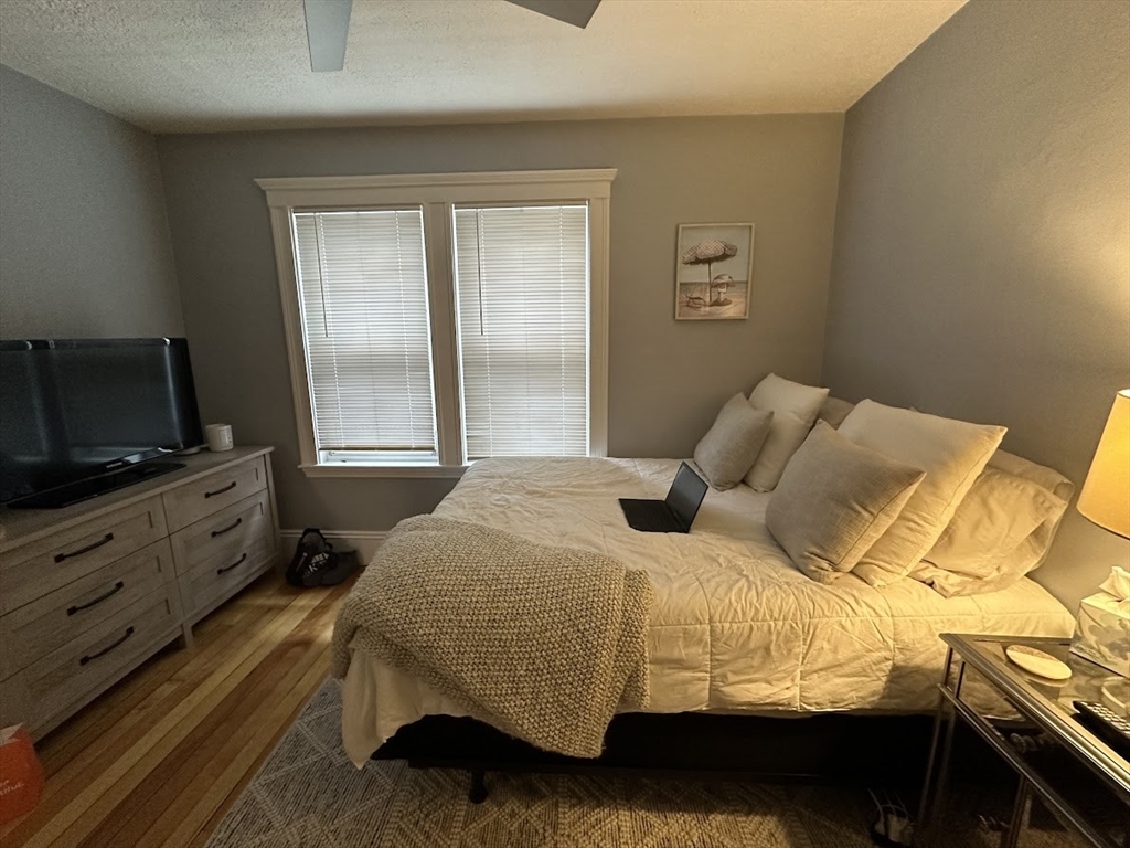 207 Boston Avenue, Unit B Medford, MA 02155 - Photo 14 of 17 a bedroom with a bed and flat screen tv