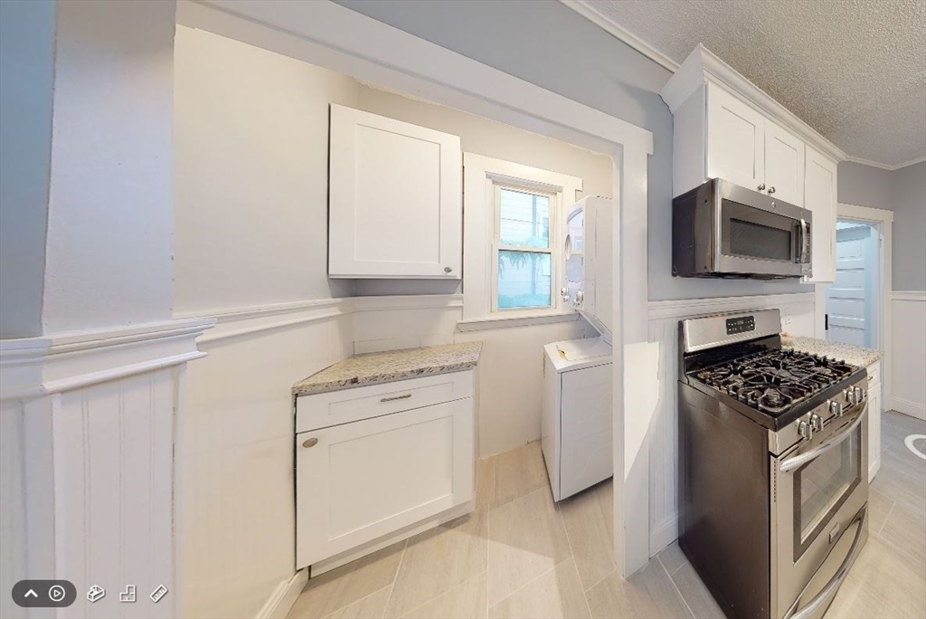 207 Boston Avenue, Unit B Medford, MA 02155 - Photo 2 of 17 a kitchen with white cabinets and appliances
