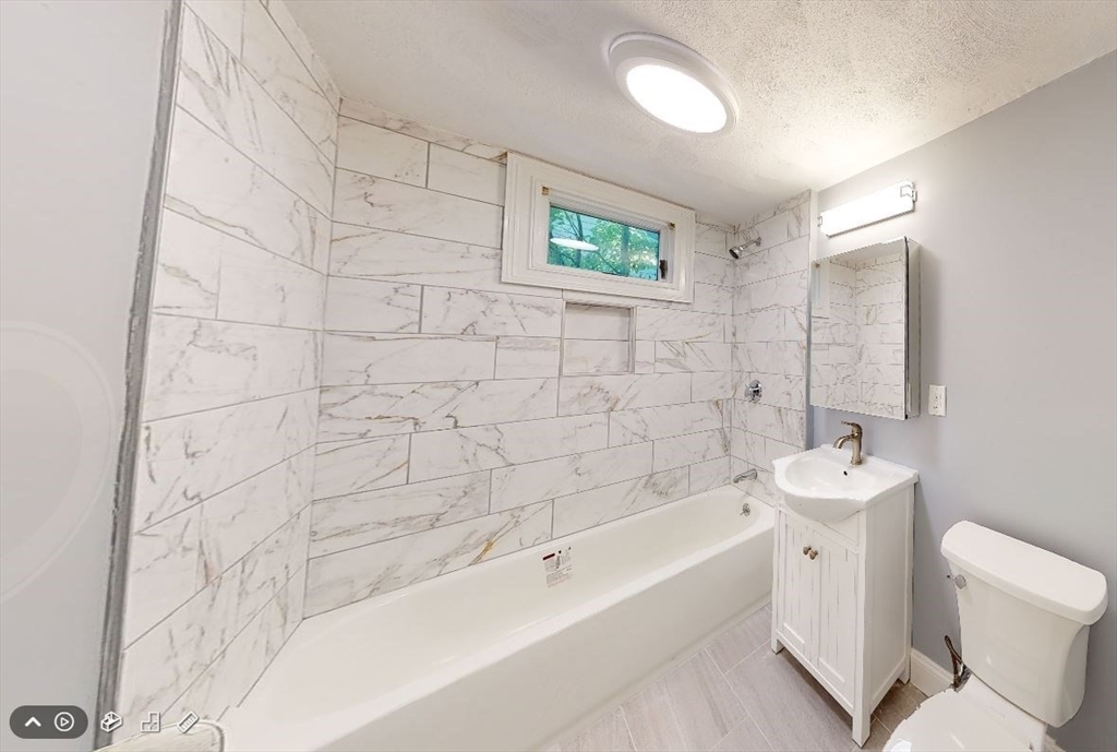 207 Boston Avenue, Unit B Medford, MA 02155 - Photo 3 of 17 a bathroom with a sink a toilet and shower