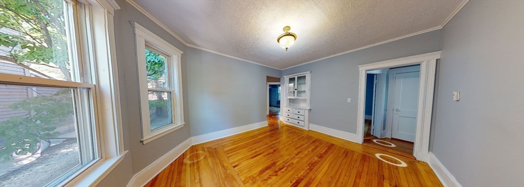 207 Boston Avenue, Unit B Medford, MA 02155 - Photo 8 of 17 a bed sitting in a bedroom next to a window