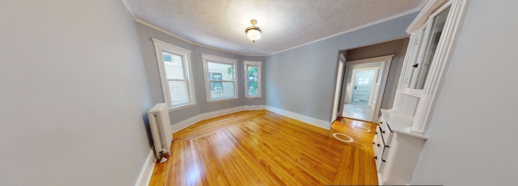 207 Boston Avenue, Unit B Medford, MA 02155 - Photo 9 of 17 a bed sitting in a bedroom next to a window