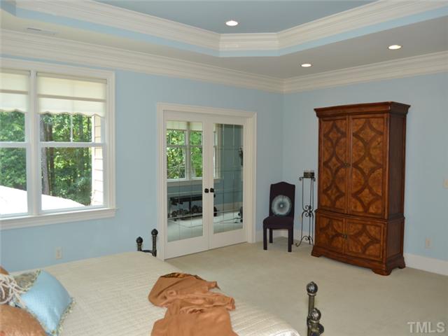 9009 Albatross Court Raleigh, NC 27613 - Photo 19 of 25 a bedroom with a bed and a window
