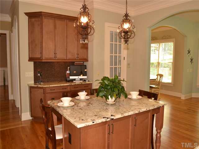 9009 Albatross Court Raleigh, NC 27613 - Photo 4 of 25 a bathroom with a granite countertop sink a mirror and chandelier